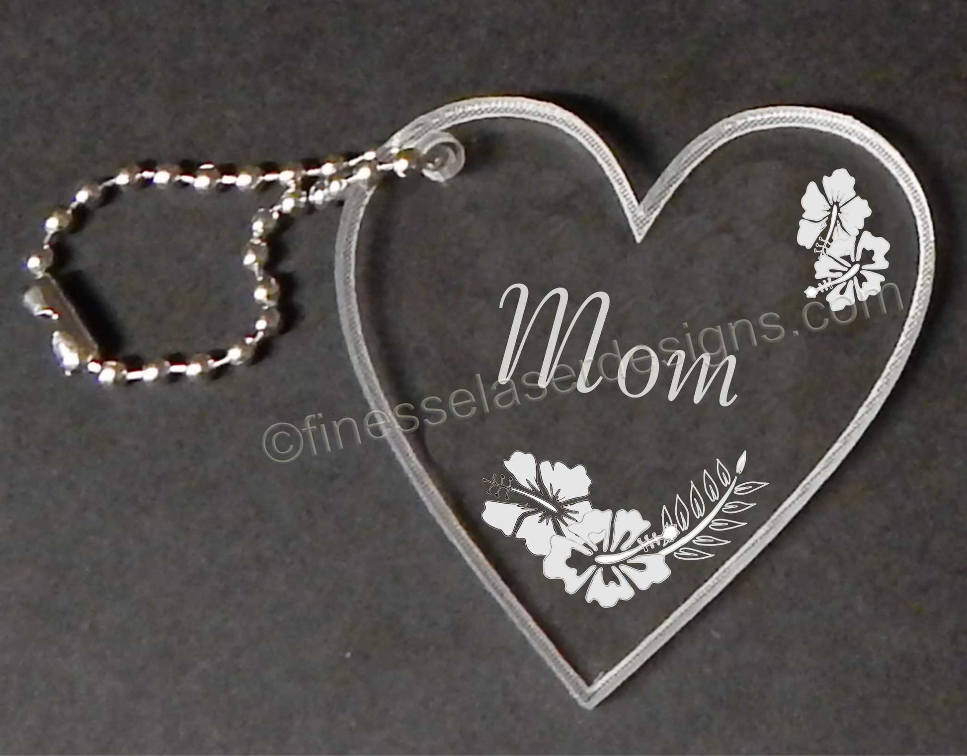 heart shaped acrylic key chain with hibiscus hearts and Mom engraved including a small metal chain attached