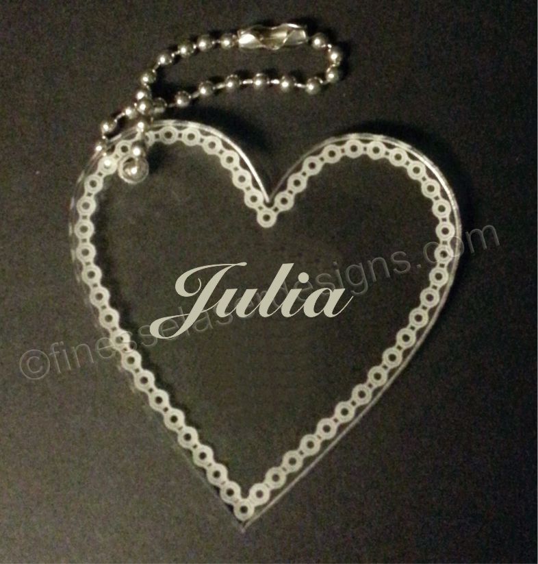 acrylic heart shaped keychain with chain border and name with small metal chain attached