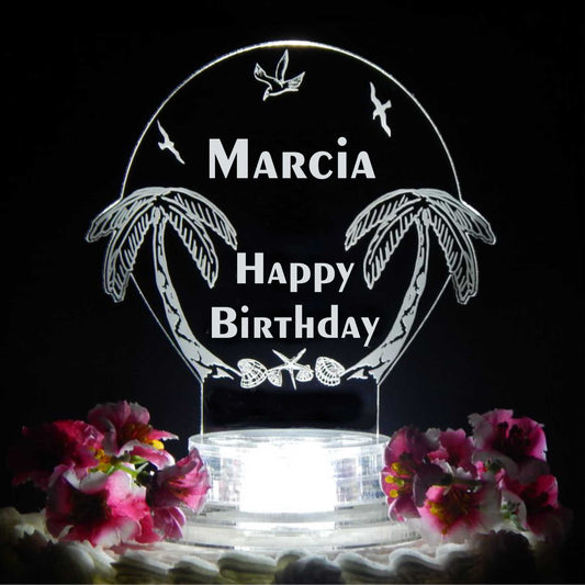 acrylic cake topper designed with palm trees and seagulls, with Happy Birthday and name engraved
