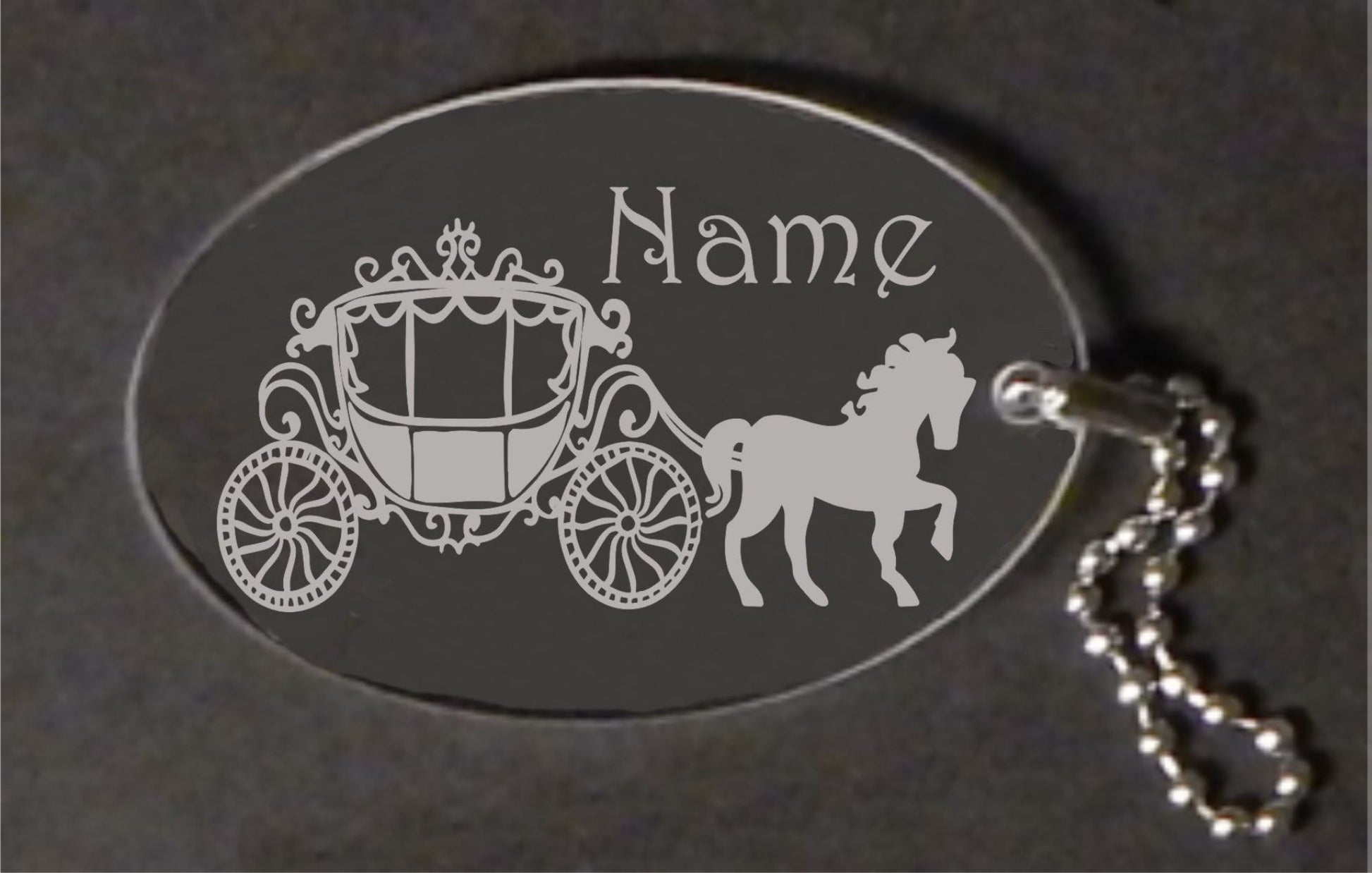 oval acrylic keychain designed with a horse and carriage and name