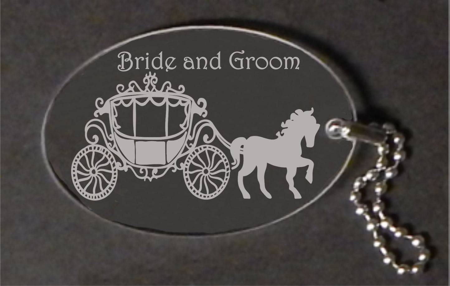 oval acrylic keychain designed with a horse and carriage, attached to a small metal chain