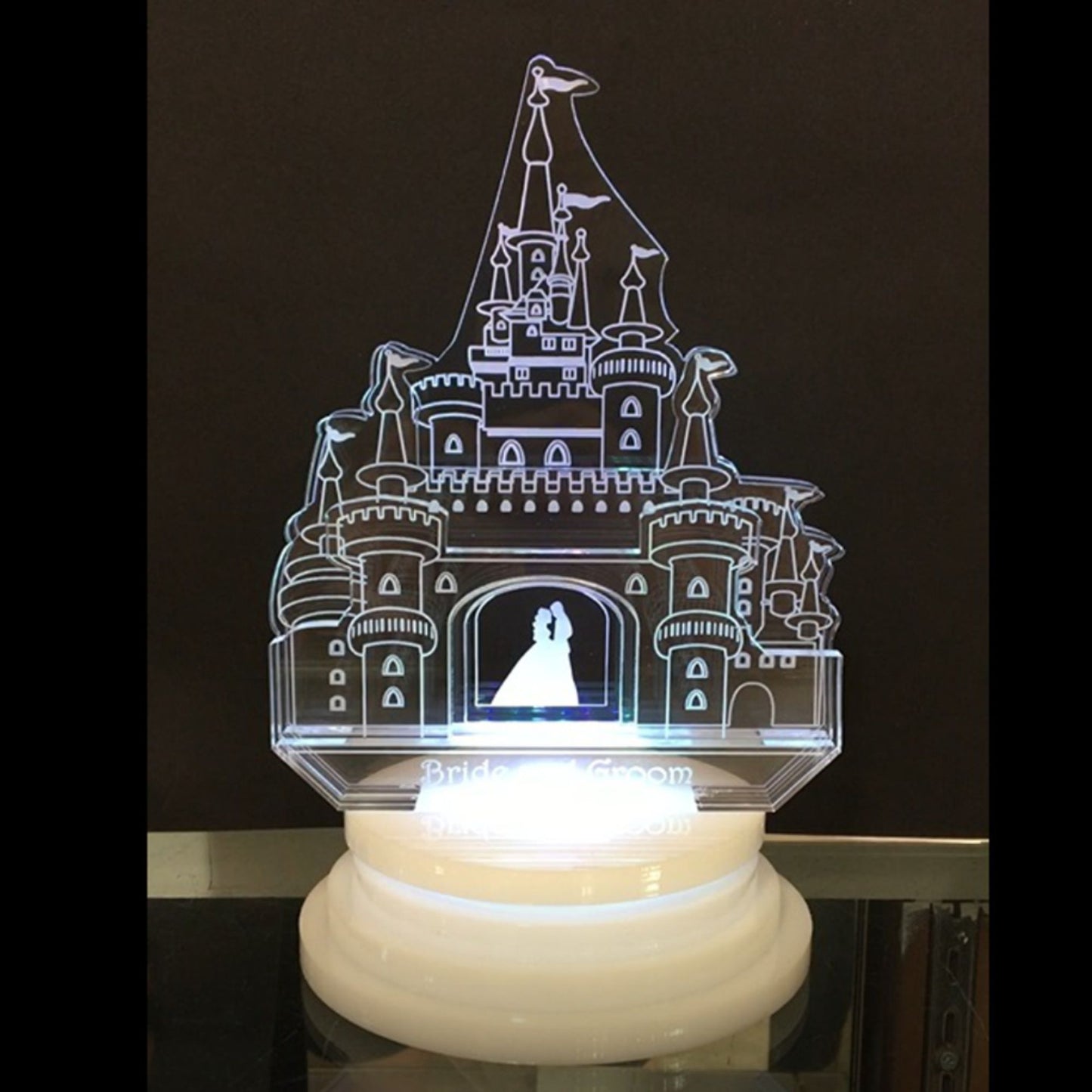 acrylic castle cake topper showing man and woman inside doorway