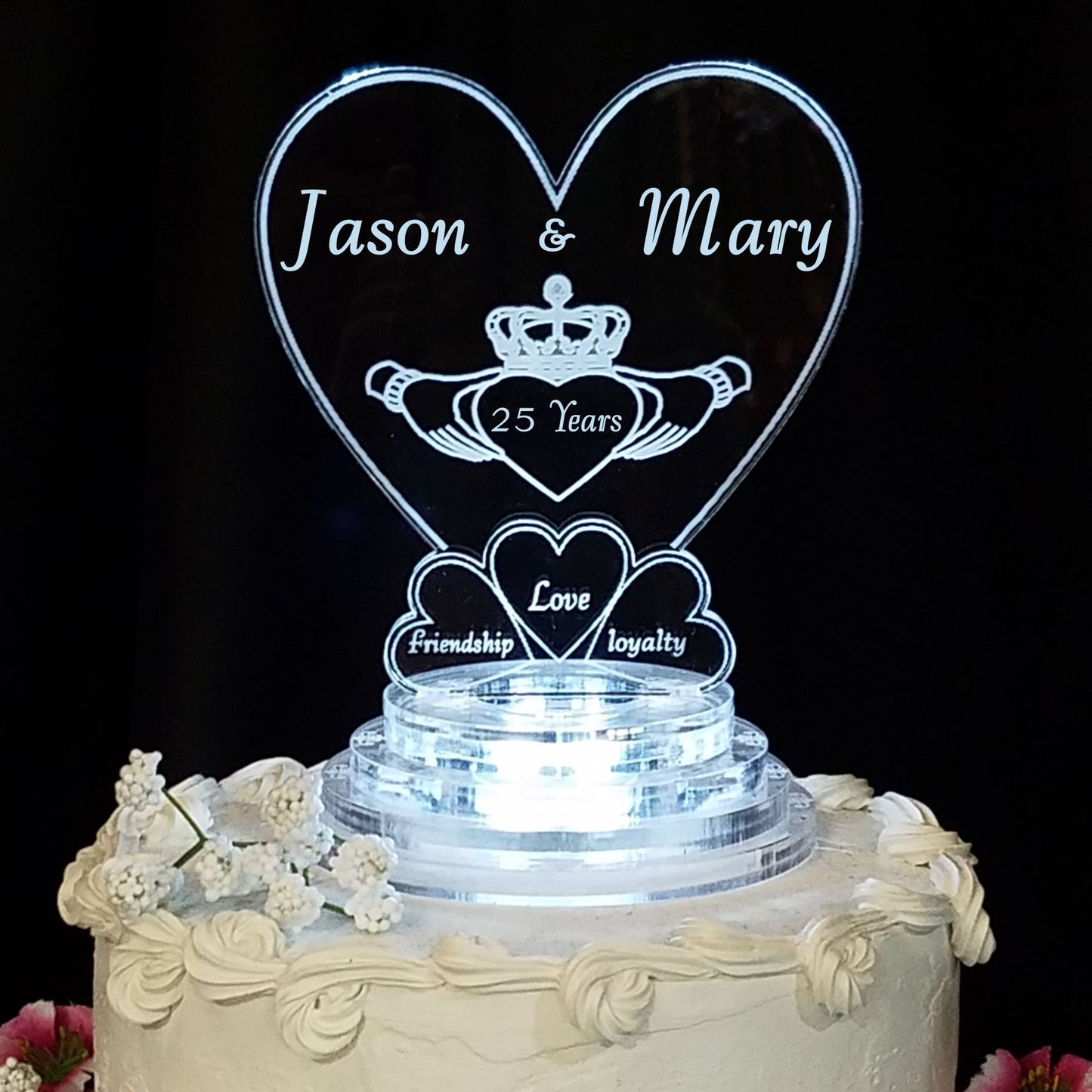 Heart shaped acrylic cake topper designed with a claddagh and engraved with names and number of years married for the anniversary