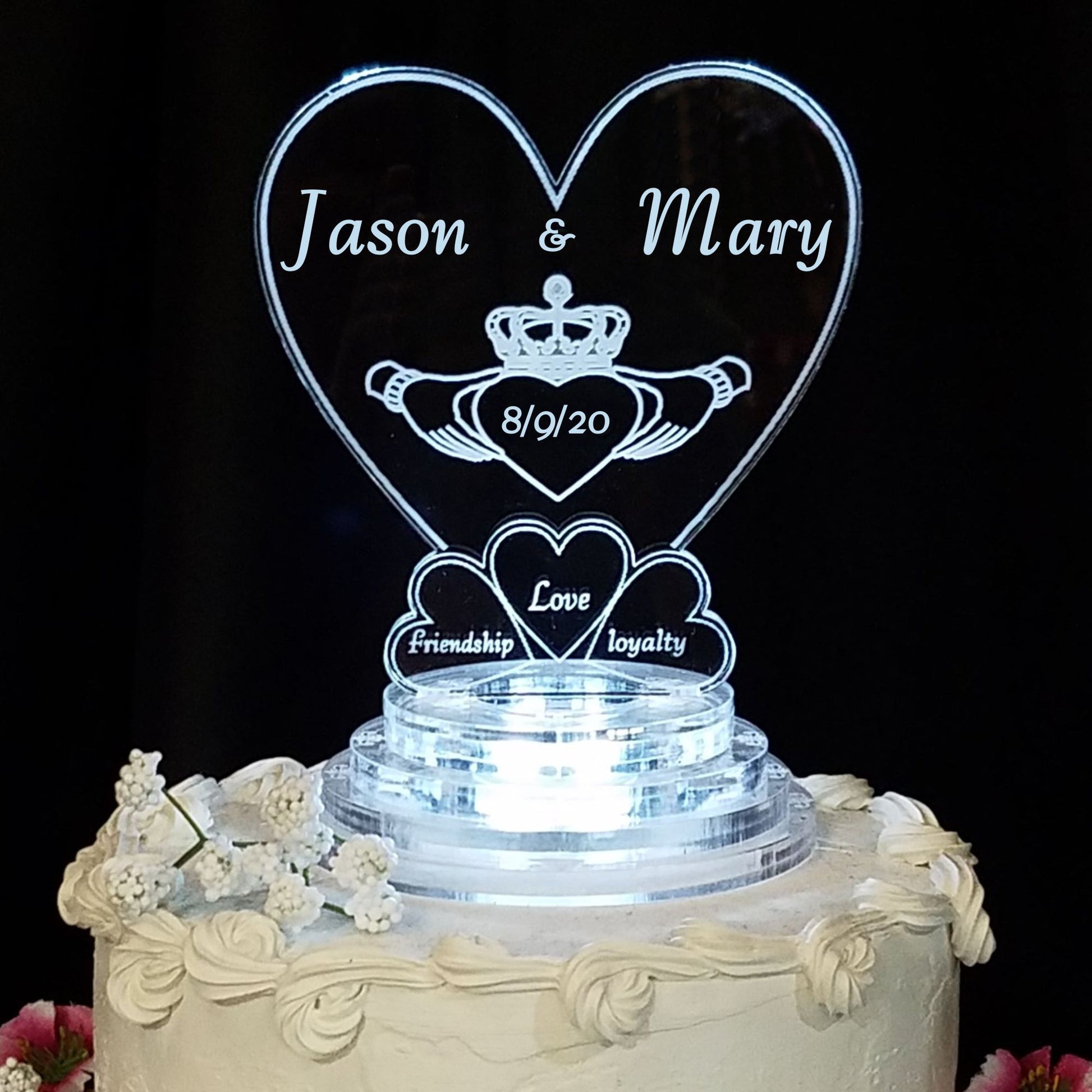acrylic heart shaped cake topper designed with a claddagh and engraved with names and date