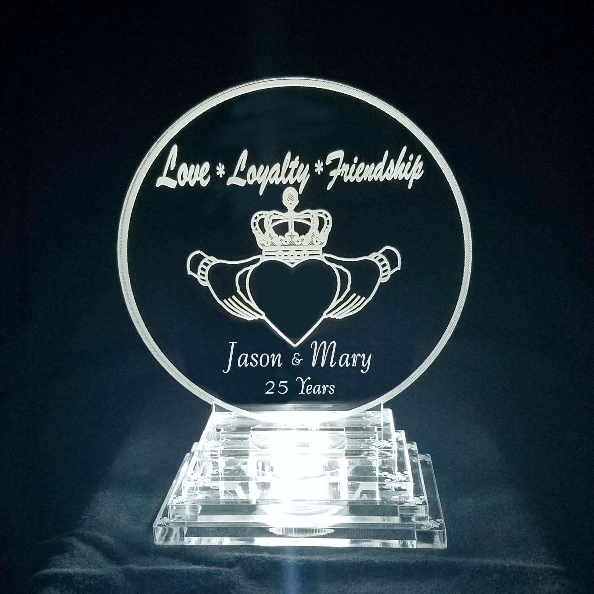 acrylic round cake topper designed with a claddagh, Love, Loyalty and Friendship and engraved with names and number of years married