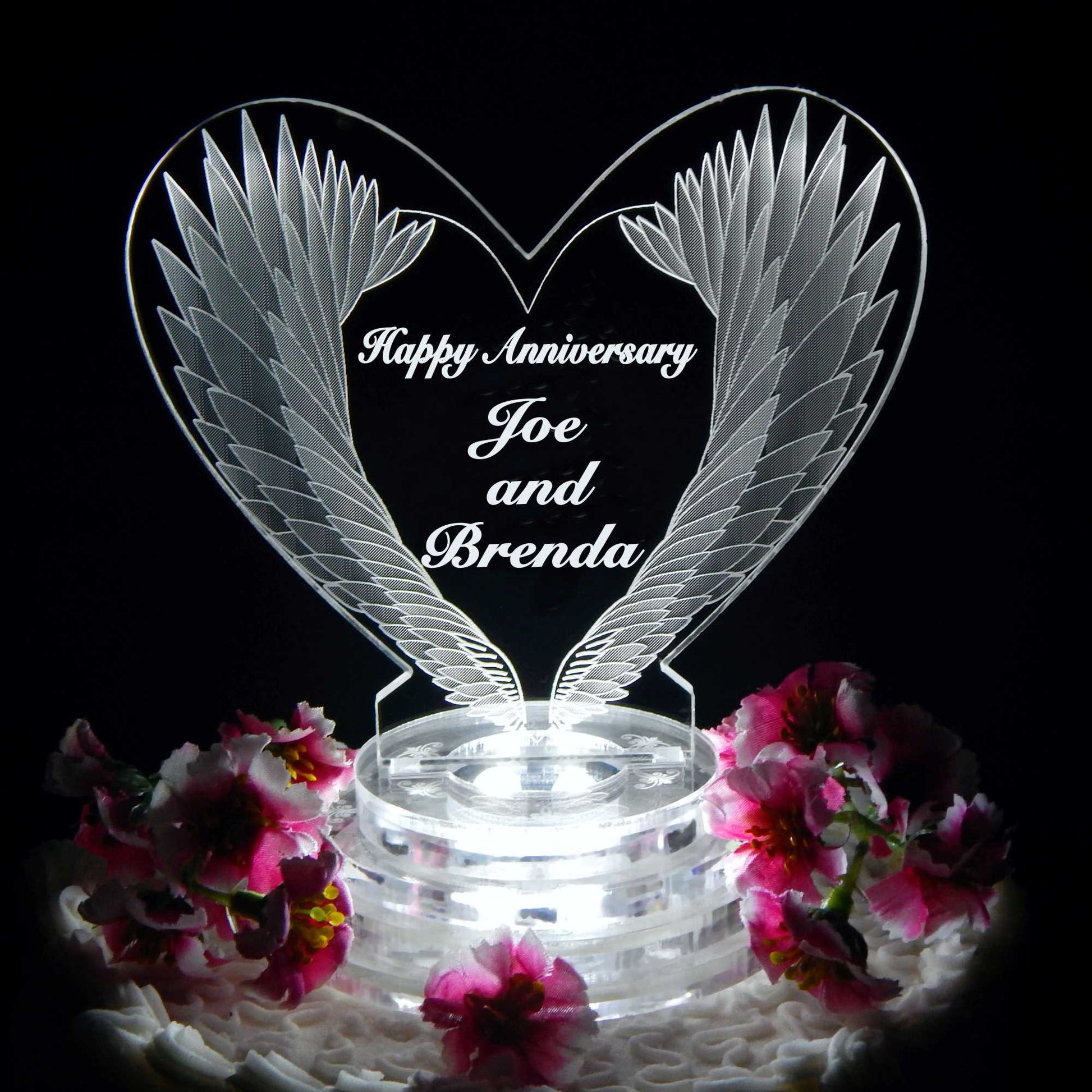 heart shaped acrylic cake topper designed with angel wing and engraved with Happy anniversary and names