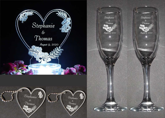 wedding package pictures showing acrylic heart shaped cake topper with hibiscus flower design, large and small acrylic keychains and a set of 2 champage flutes