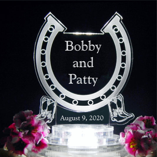 horseshoe shaped acrylic cake topper designed with a horseshoe design and engraved with names and date