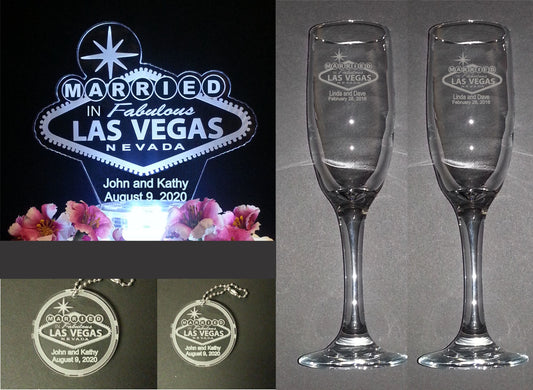 photo showing a Married in Las Vegas sign cake topper, two sizes in round keychains, and a set of champagne flutes with a Las Vegas design