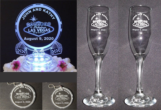 photo showing round acrylic cake topper with a Las Vegas design, 2 sizes in round acrylic keychain favors, and a set of 2 champagne flutes - all with a Las Vegas design