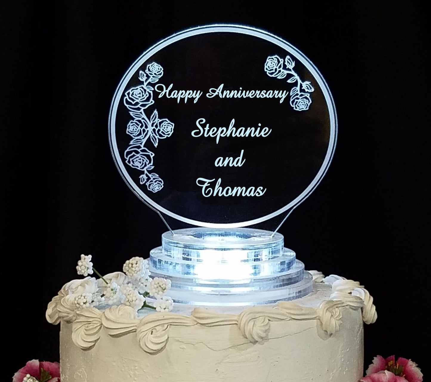 clear acrylic cake topper designed in a rose and rosebud theme,  engraved with Happy Anniversary and names
