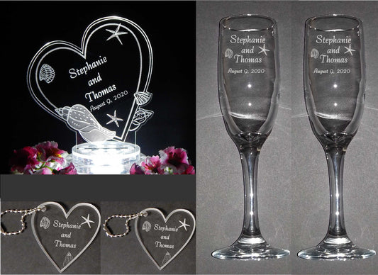 photo showing wedding package with an acrylic heart shaped seashell decorated cake topper, two sizes of acrylic keychain favors and a set of 2 champagne flutes