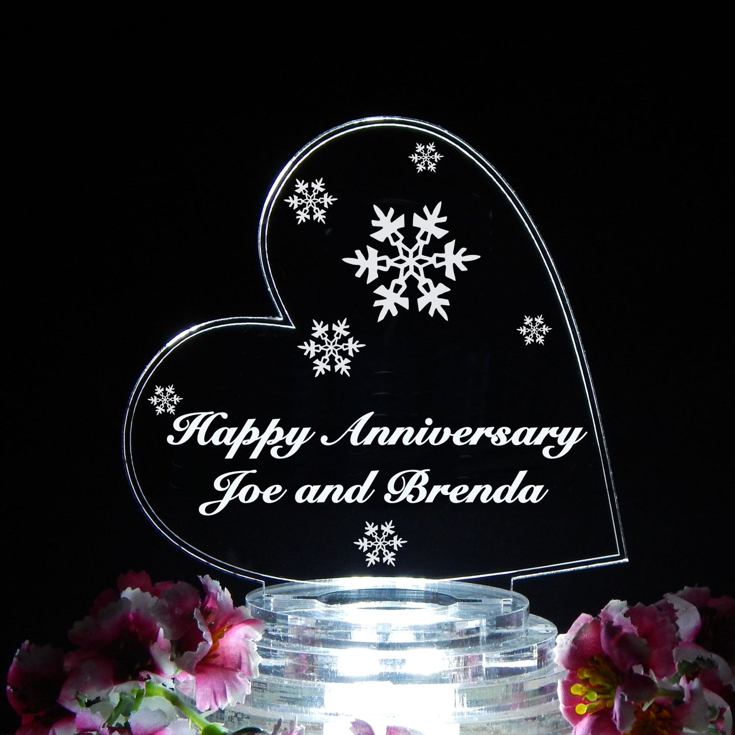 heart shaped cake topper designed with wedding snowflakes and engraved with Happy Anniversary and names