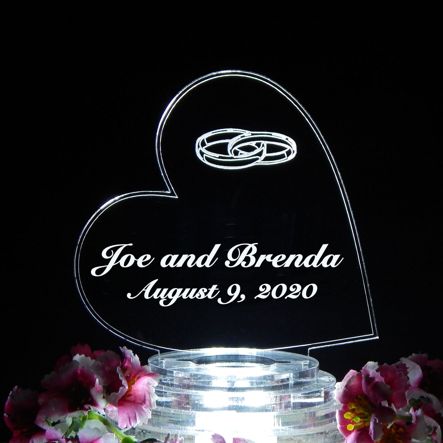 side heart shaped acrylic cake topper designed with wedding rings and engraved with names and date
