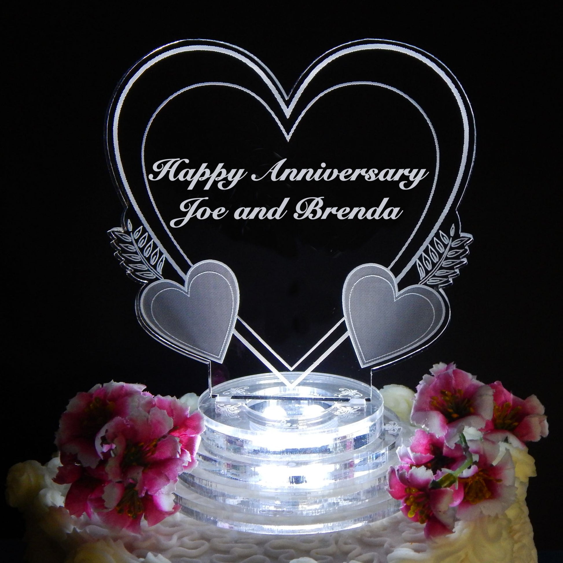 Heart shaped acrylic cake topper engraved with Happy Anniversary and names