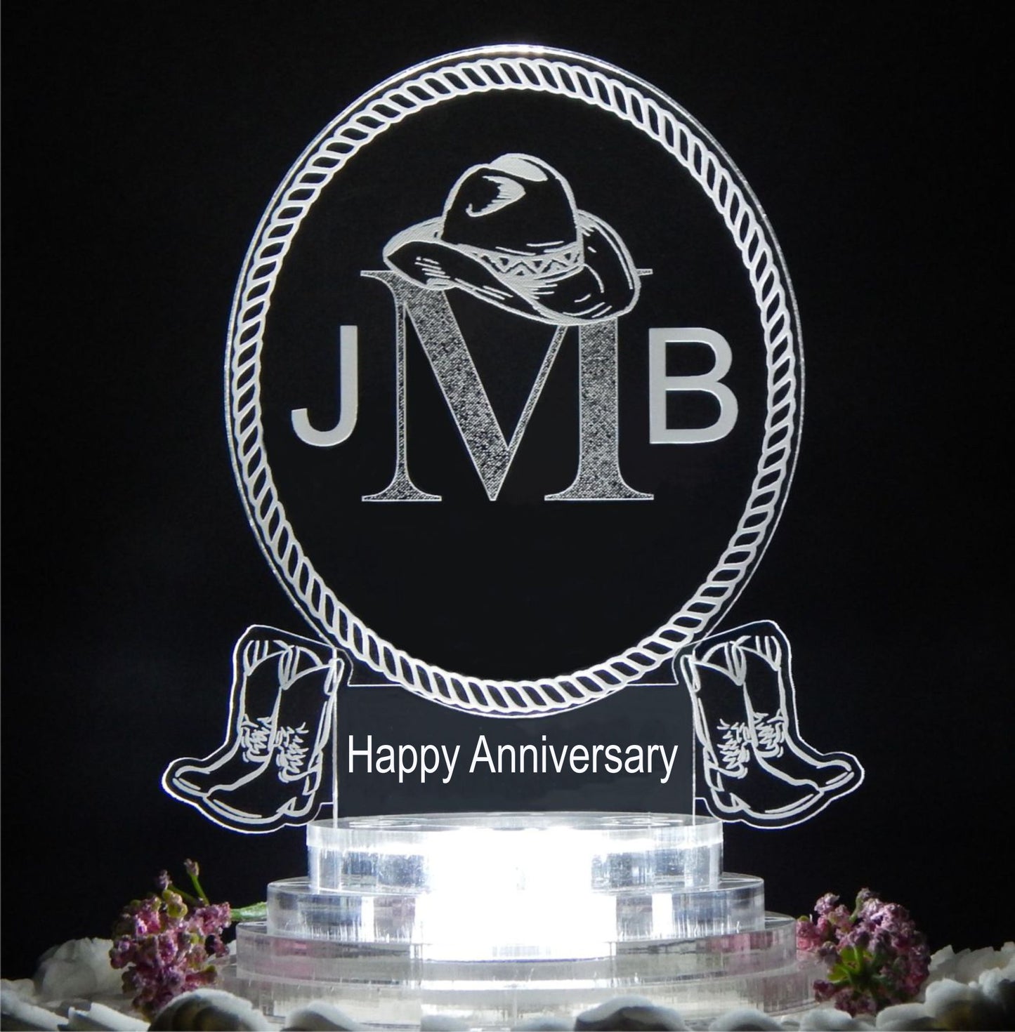 clear acrylic oval cake topper designed in a western cowboy theme engraved with a 3 letter monogram and Happy Anniversary