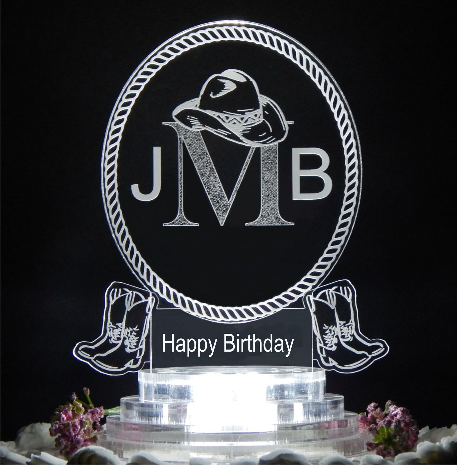 clear acrylic oval cake topper designed in a western cowboy theme engraved with a 3 letter monogram and Happy Birthday