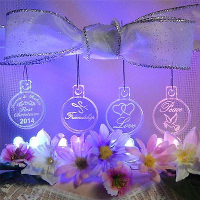 acrylic ornaments showing 4 designs with names and holly on one, Peace and dove on another, Friendship with oriental writing, and Love with two hearts