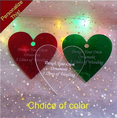 3 heart shaped acrylic ornaments with 3 lines of wording, shown in red, green and clear acrylic
