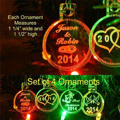 acrylic round ornaments shown with wedding rings design on one, hearts on one, wedding bells on one, and doves on the last