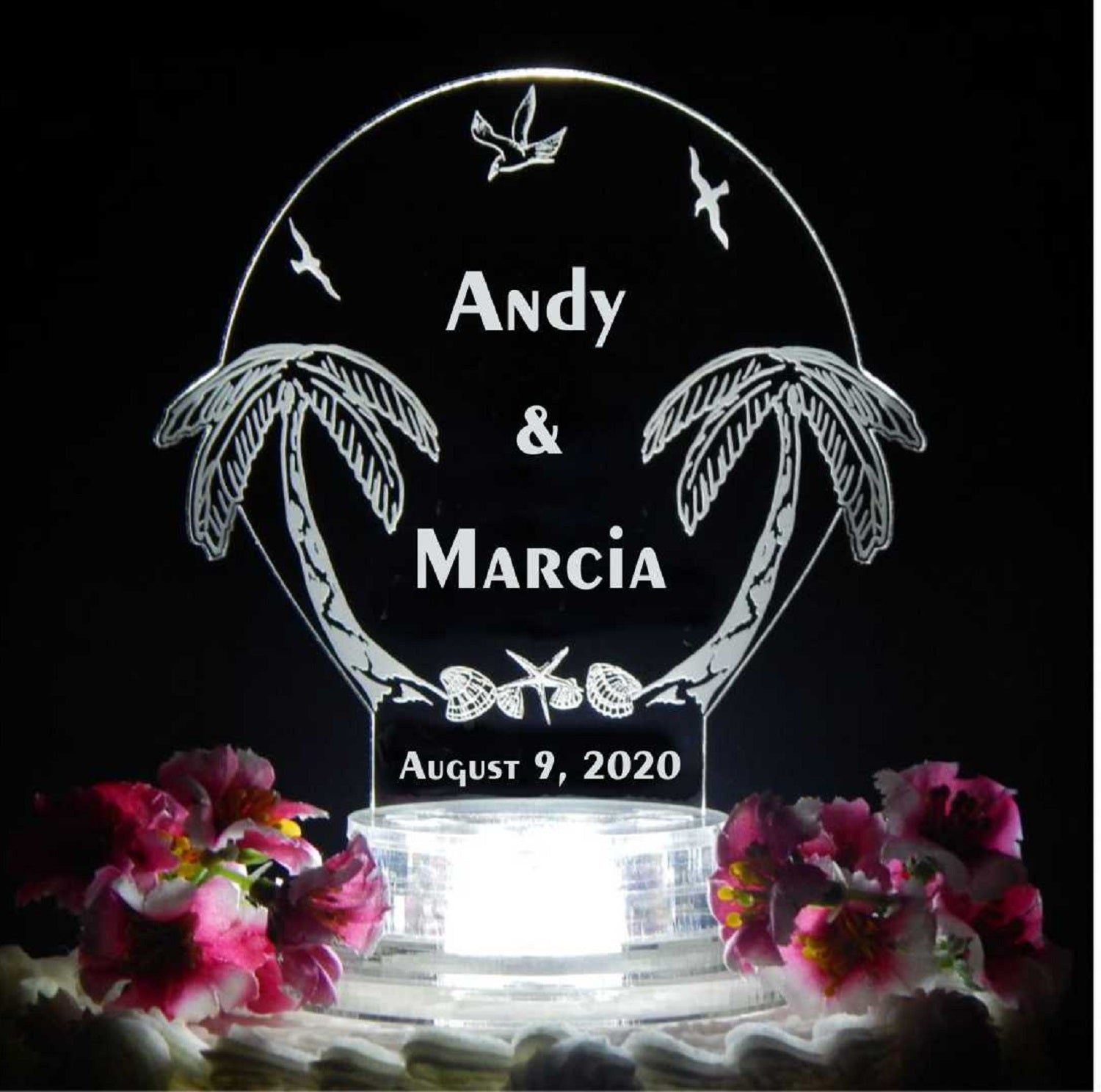 acrylic cake topper designed with palm trees along with names and date