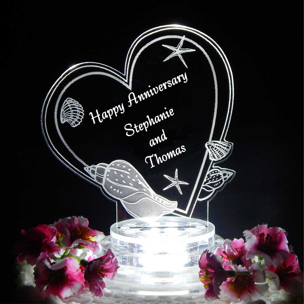 heart shaped cake topper designed with seashells, Happy Anniversary and names