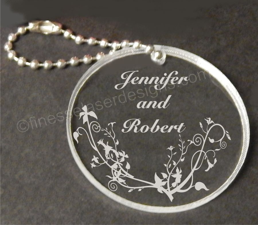 acrylic round shaped keychain with butterflies and names engraved along with small metal chain attached
