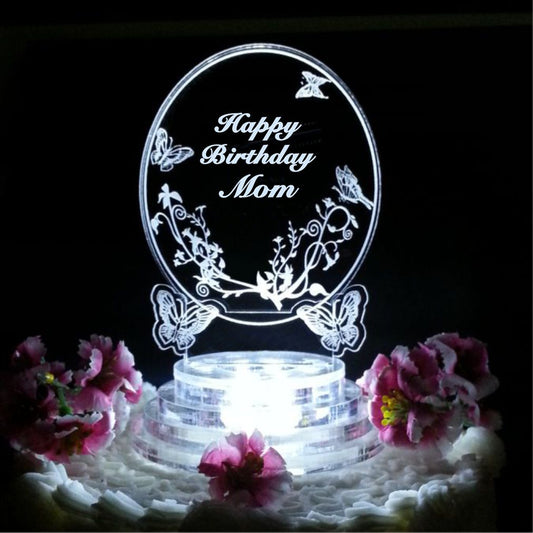 acrylic oval shaped cake topper with butterflies engraved along with Happy Birthday and name