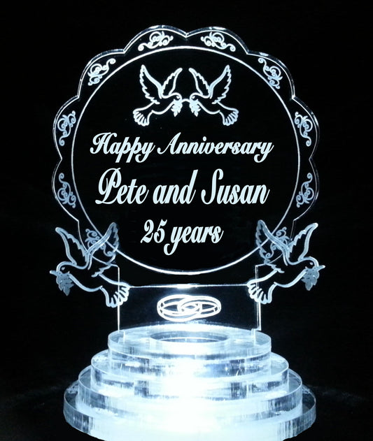 Acrylic lighted cake topper with dove theme and wedding rings, along with names and Happy Anniversary