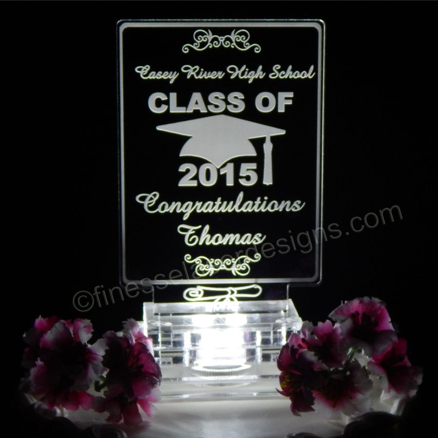 acrylic cake topper showing a cap and scroll design with school name, Congratulations Name and Class of Year