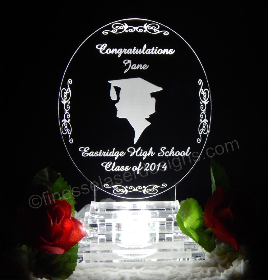 oval acrylic cake topper shown with girl silouette along with name and school name
