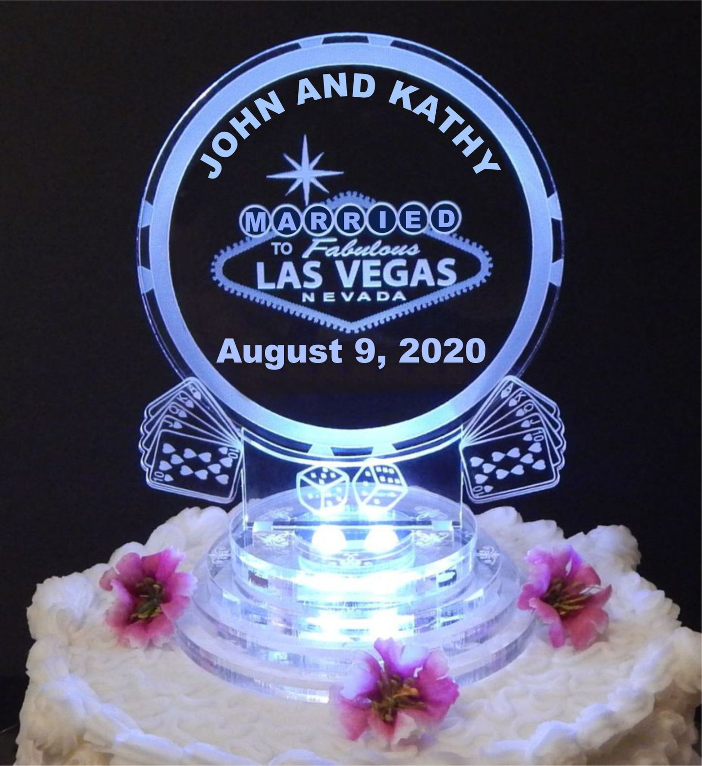Lighted acrylic cake topper designed with Las Vegas poker chip, cards, dice along with names and date.