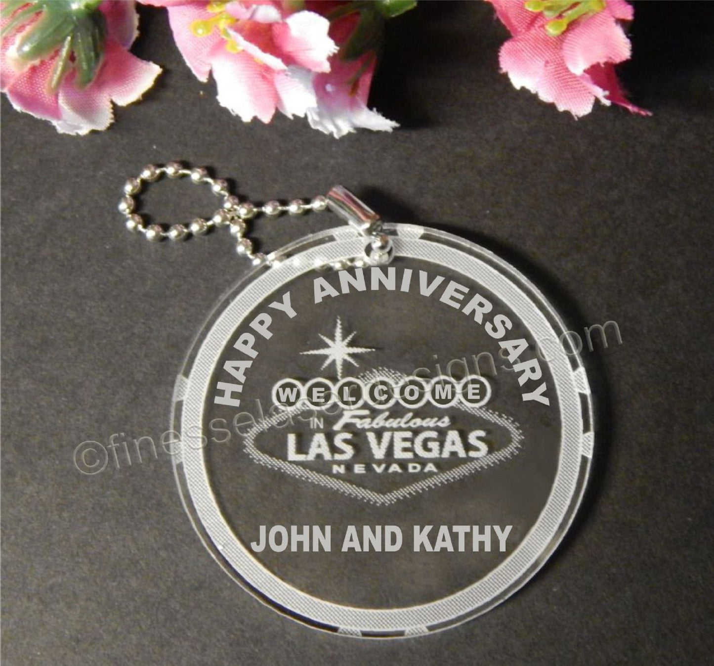 Round acrylic keychain designed with Welcome to Las Vegas sign and Happy Anniversary, along with names