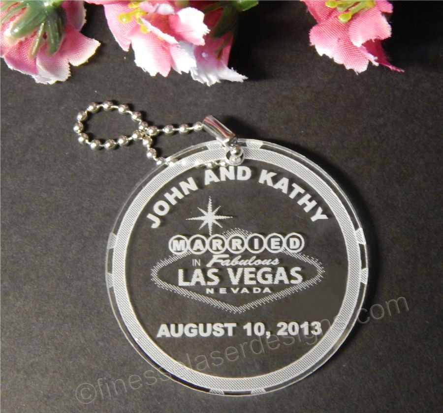 round acrylic keychain with a Married in Las Vegas sign along with names and date with a small metal chain attached
