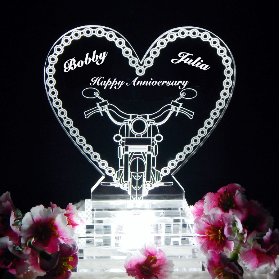 acrylic heart shaped cake topper with a motorcycle chain border and front view of a motorcycle, including Happy Anniversary and names