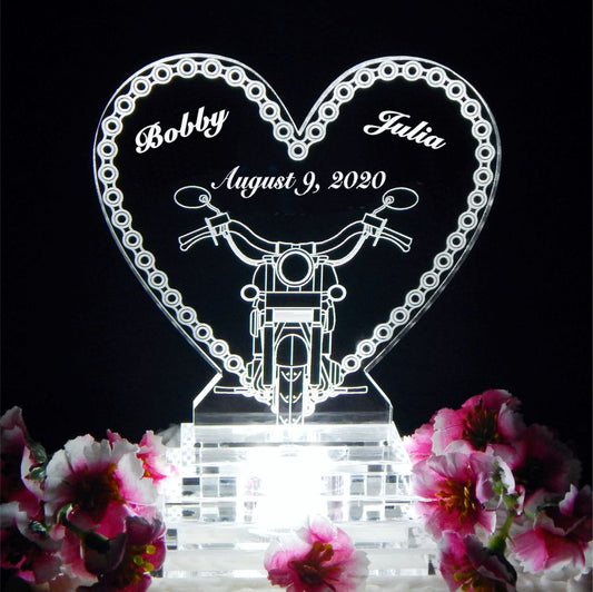 acrylic heart shaped cake topper with a motorcycle chain border and front view of a motorcycle, including names and date
