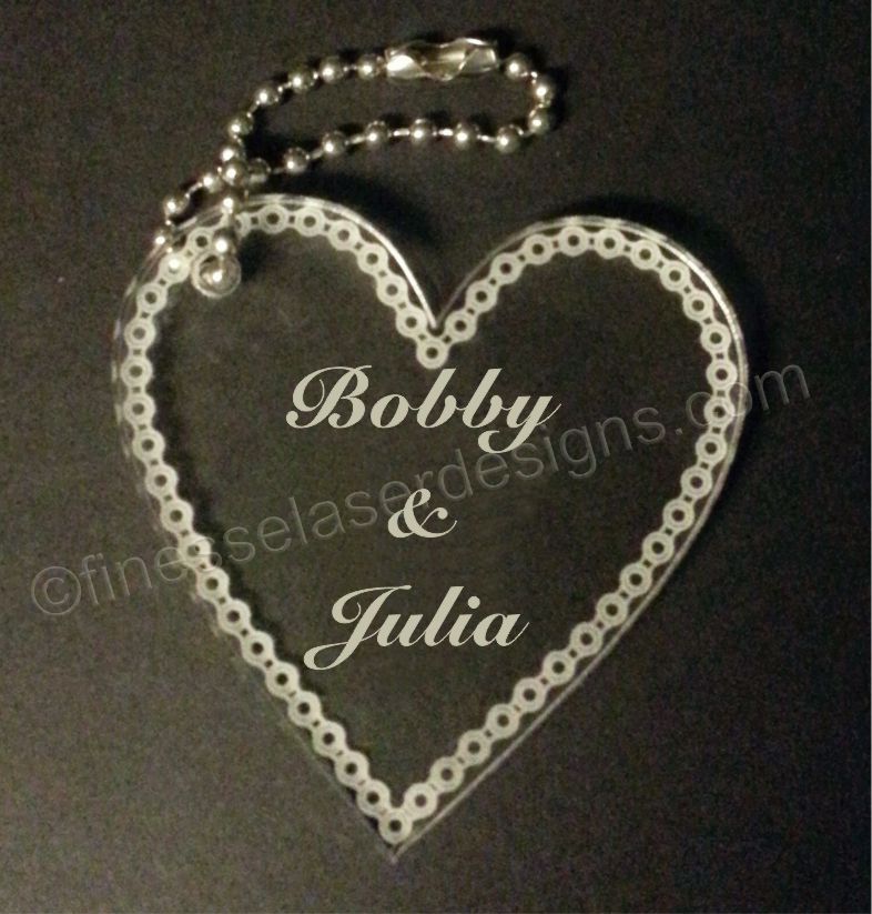 hear shaped acrylic keychain with names and chain border with small metal chain attached