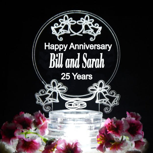 acrylic cake topper designed with bells and wedding rings and includes Happy Anniversay with names and number of years