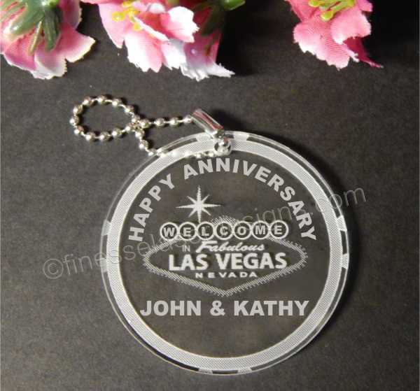 round acrylic keychain with a Welcome to Las Vegas sign along with names and Happy Anniversary with a small metal chain attached