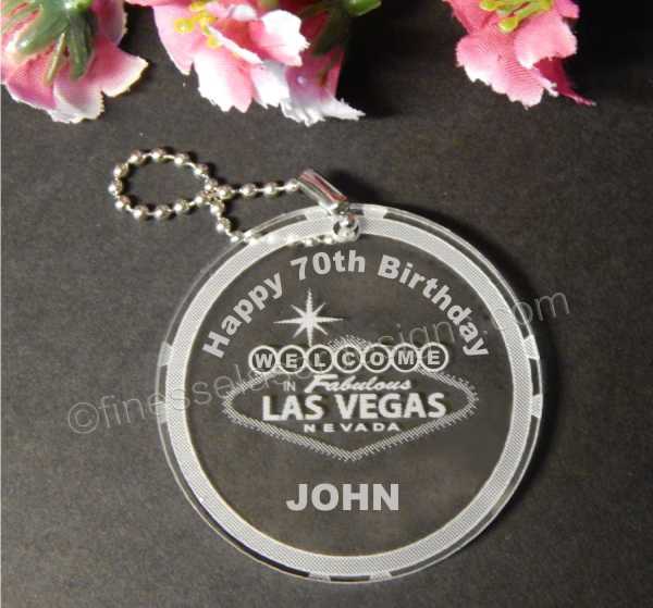 round acrylic keychain with a Welcome to Las Vegas sign along with name and Happy 70th Birthday with a small metal chain attached