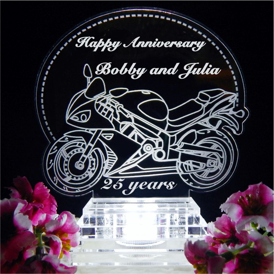 acrylic cake topper with side view of a sports motorcycle and Happy Anniversary with names engraved
