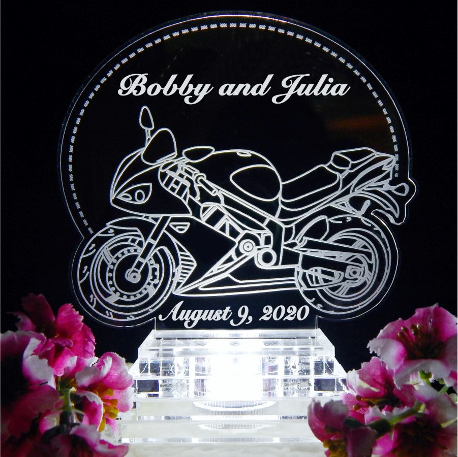 acrylic cake topper with side view of a sports motorcycle along with names and date engraved