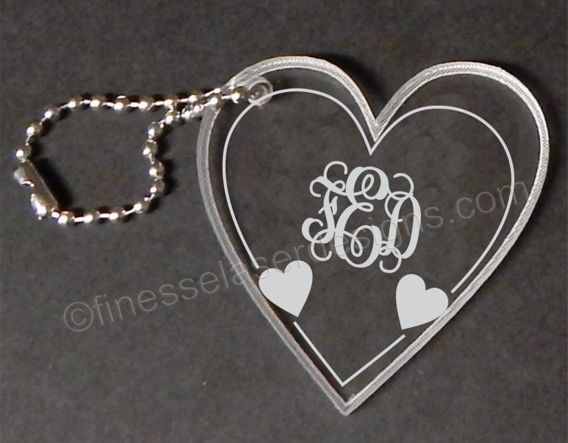 heart shaped keychain shown with monogram and hearts with a small metal chain attached