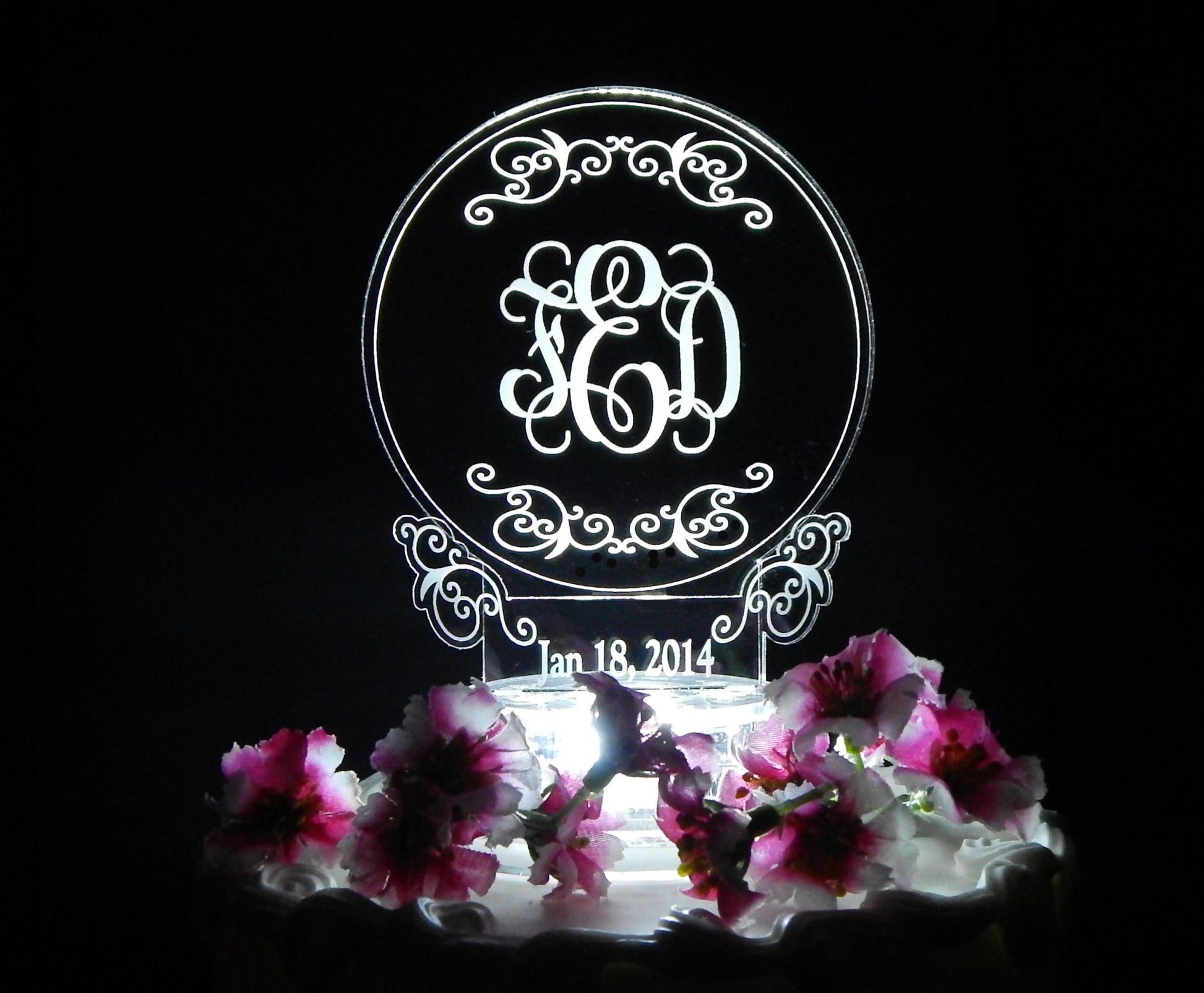 Round acrylic cake topper with a simplistic design with monogram and date 