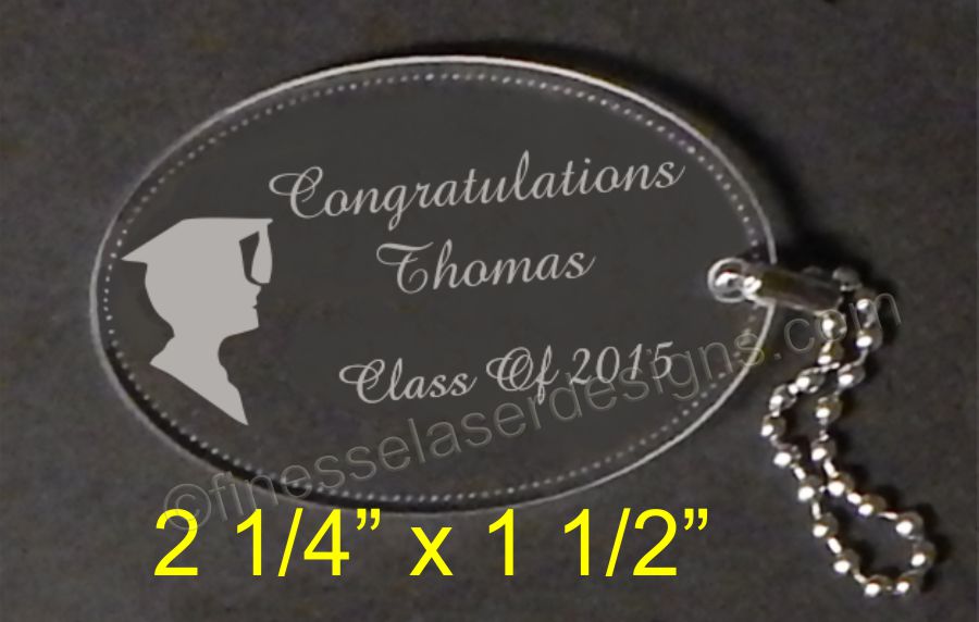 Oval keychain engraved with boy silhouette and Congratualtions with small metal chain attached